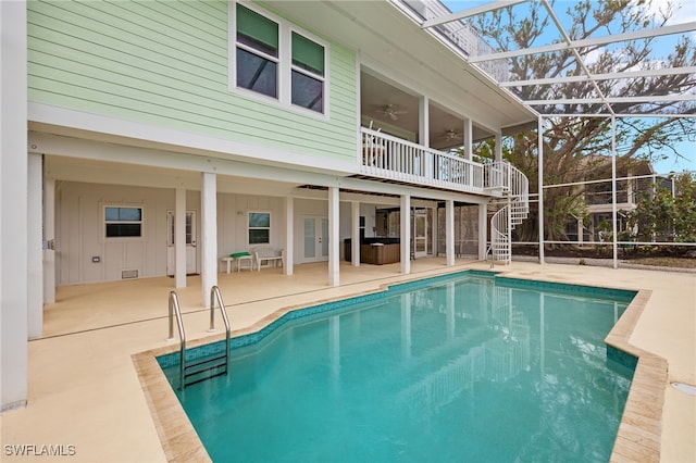 view of swimming pool featuring a lanai, ceiling fan, and a patio area