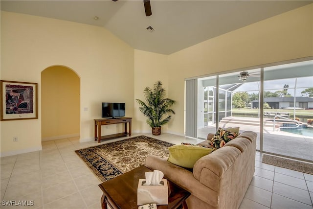 tiled living room with high vaulted ceiling