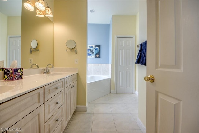 bathroom featuring tile patterned flooring, vanity, and a bathing tub