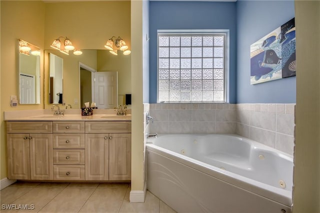 bathroom with tile patterned flooring, a washtub, and vanity