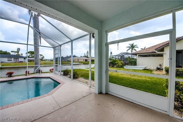 view of pool with a lanai, a yard, a water view, and a patio