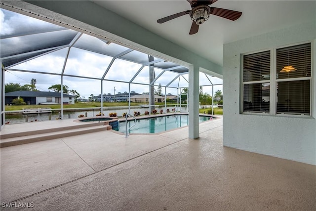 view of pool with a water view, ceiling fan, a lanai, an in ground hot tub, and a patio area