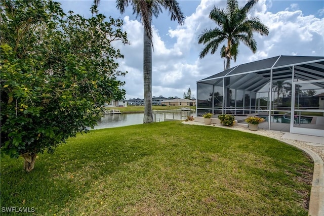 view of yard featuring glass enclosure and a water view