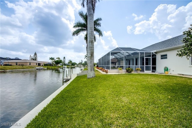 view of yard with a lanai, a dock, and a water view