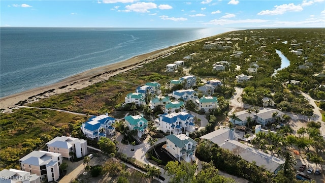 drone / aerial view with a water view and a beach view