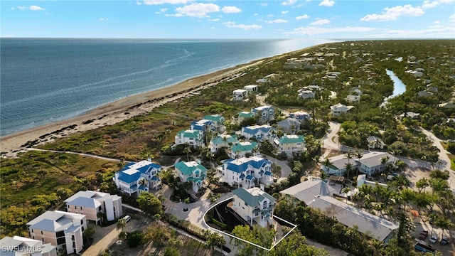 bird's eye view with a water view and a beach view