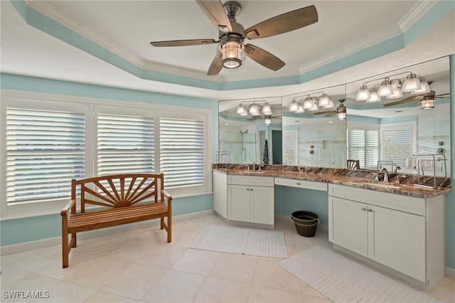 bathroom with tile patterned floors, vanity, a tray ceiling, crown molding, and a shower with shower door