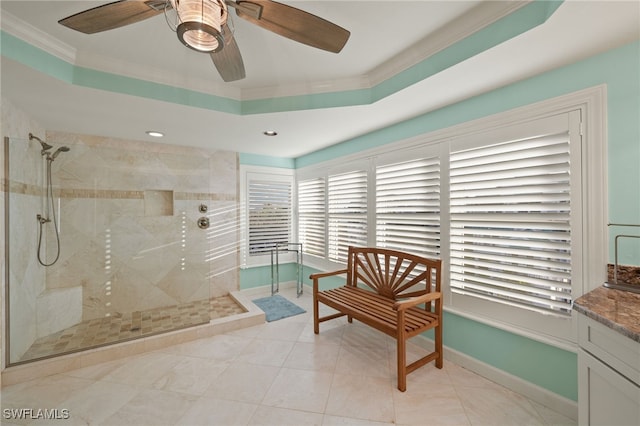 bathroom with ceiling fan, crown molding, tiled shower, and vanity