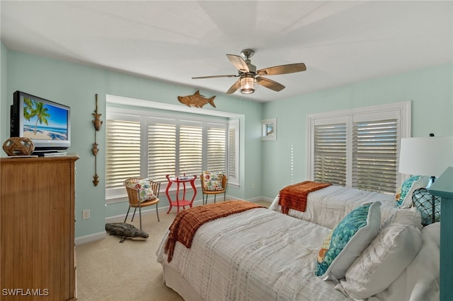 bedroom featuring light colored carpet and ceiling fan