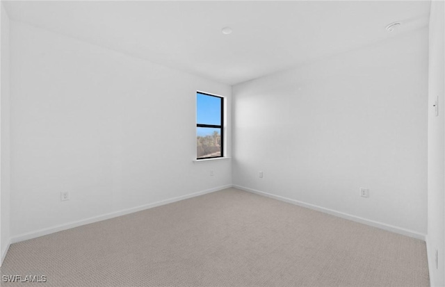 empty room featuring light colored carpet