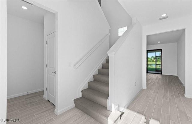 stairway featuring wood-type flooring