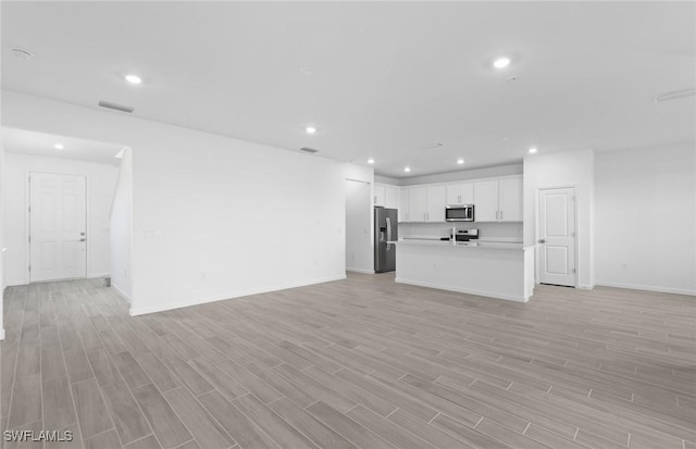 unfurnished living room with light hardwood / wood-style flooring