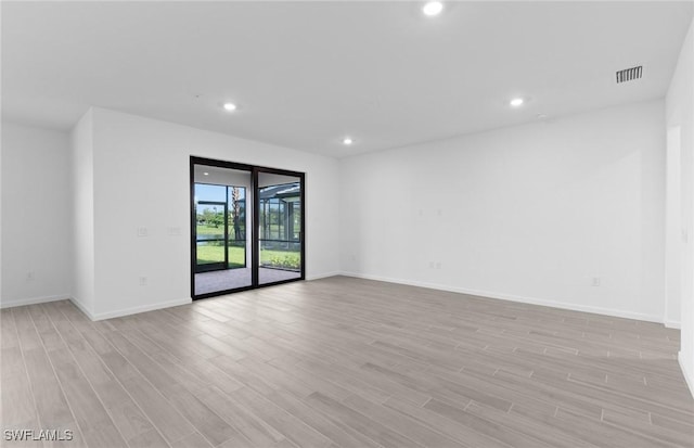 spare room featuring light wood-type flooring