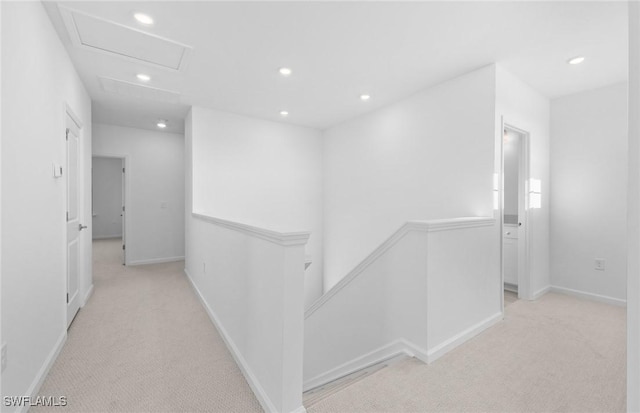 hallway with light colored carpet