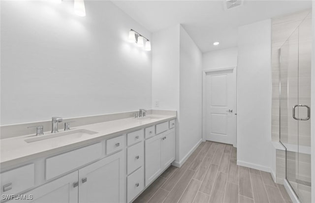 bathroom with vanity and an enclosed shower