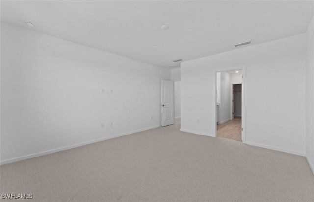 unfurnished room with light colored carpet