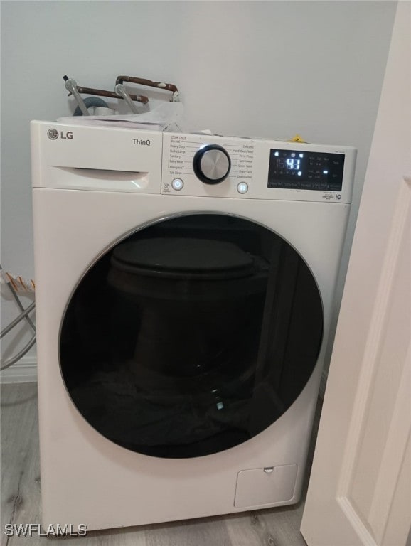 5761 Foxlake Dr Unit A, North Fort Myers, FL 33917 - laundry area featuring washer / clothes dryer and wood finished floors