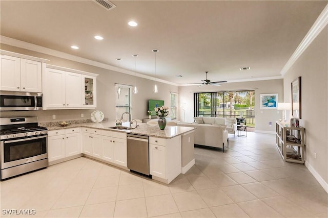 kitchen featuring sink, ceiling fan, light stone countertops, appliances with stainless steel finishes, and white cabinetry