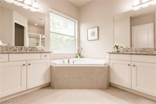 bathroom featuring tile patterned floors, vanity, and shower with separate bathtub