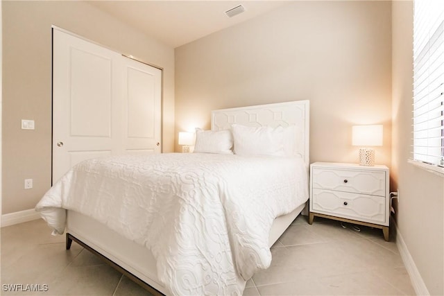 bedroom featuring tile patterned flooring and a closet