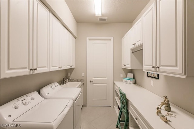 washroom featuring sink, cabinets, separate washer and dryer, a textured ceiling, and light tile patterned flooring