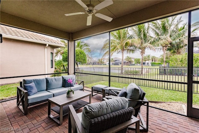 sunroom featuring ceiling fan