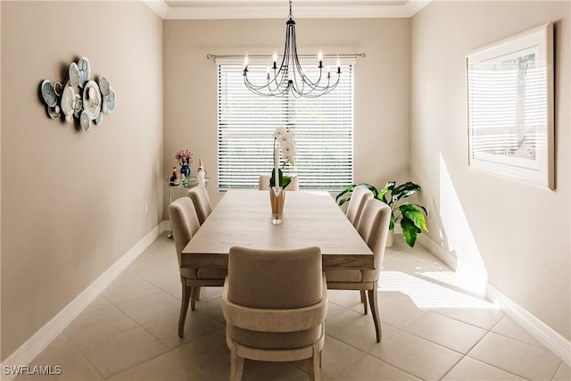 dining space featuring a wealth of natural light, light tile patterned flooring, ornamental molding, and a notable chandelier