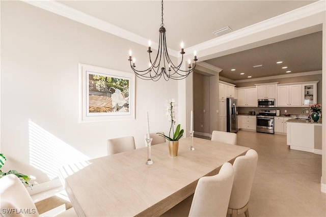 dining area with crown molding, sink, and a notable chandelier