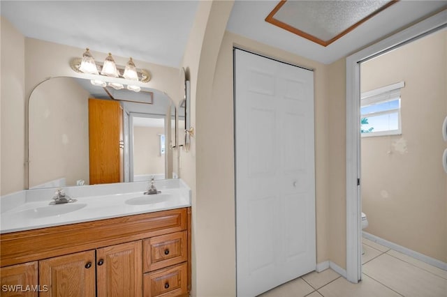 bathroom with tile patterned floors, vanity, and toilet