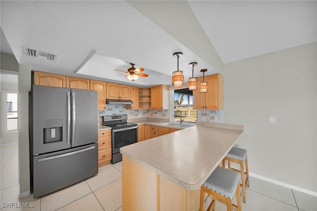 kitchen featuring a kitchen bar, kitchen peninsula, sink, and appliances with stainless steel finishes