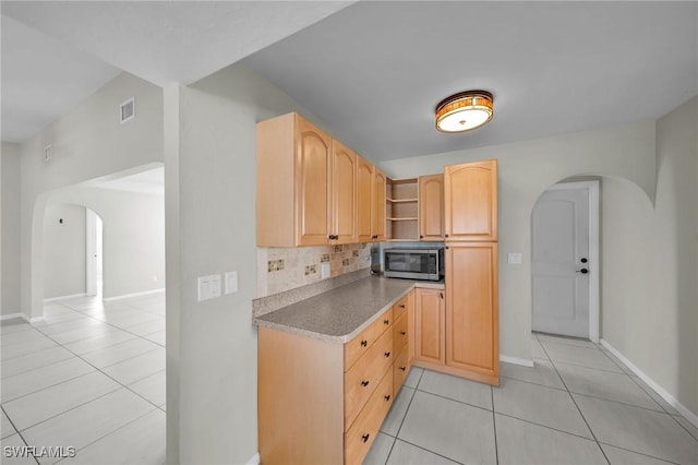 kitchen featuring light brown cabinetry, tasteful backsplash, and light tile patterned floors