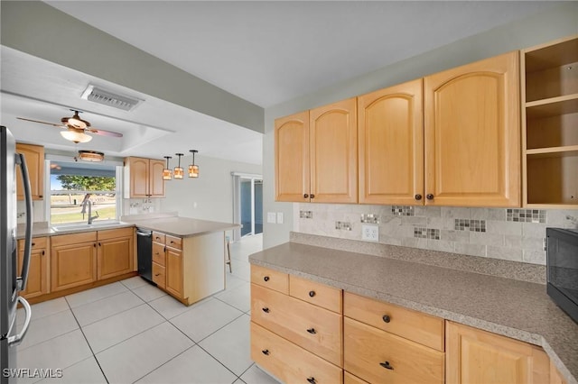 kitchen with pendant lighting, light brown cabinets, sink, ceiling fan, and kitchen peninsula