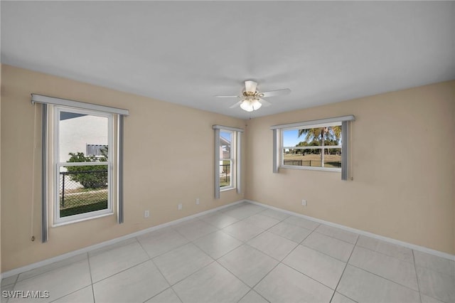 empty room with light tile patterned floors and ceiling fan