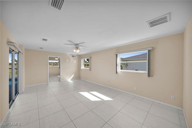 unfurnished room with ceiling fan and light tile patterned floors