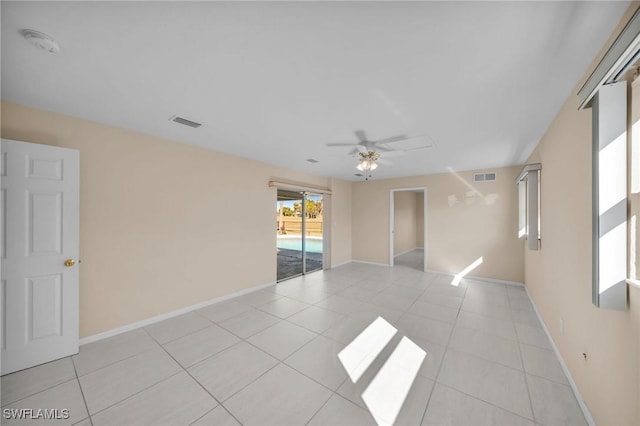 empty room with light tile patterned floors and ceiling fan