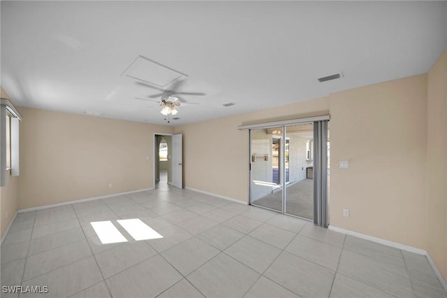 spare room featuring ceiling fan and light tile patterned floors