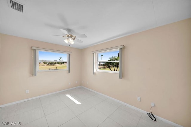 unfurnished room with ceiling fan and light tile patterned flooring