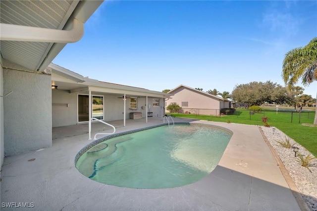 view of pool with a lawn and a patio area