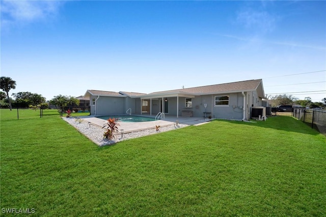 rear view of house with a fenced in pool, central air condition unit, a sunroom, and a yard