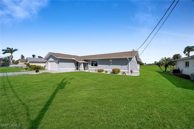 ranch-style home with central AC unit, a garage, and a front lawn