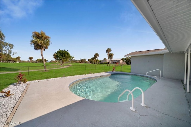 view of swimming pool featuring a lawn and a patio