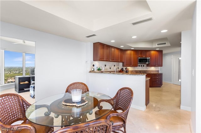 dining area with a raised ceiling