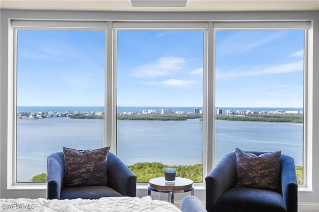 bedroom with multiple windows and a water view