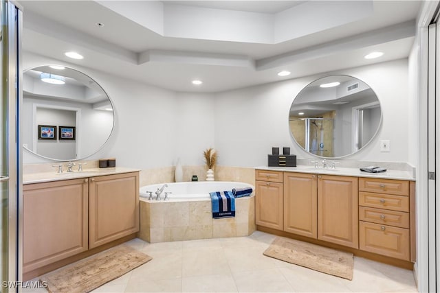 bathroom with separate shower and tub, tile patterned floors, a tray ceiling, and vanity