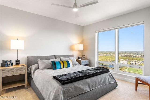 carpeted bedroom with ceiling fan and multiple windows