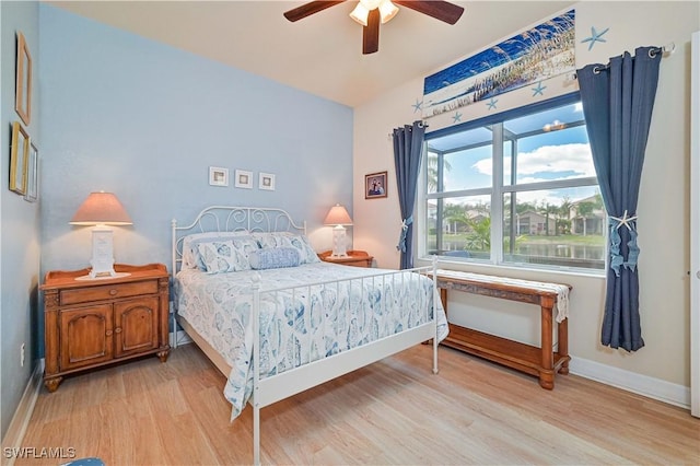 bedroom with ceiling fan and light wood-type flooring