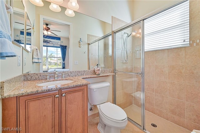 bathroom with an enclosed shower, vanity, ceiling fan, tile patterned flooring, and toilet