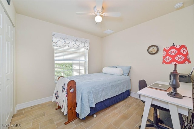 bedroom featuring ceiling fan, light hardwood / wood-style floors, and a closet