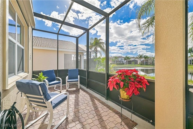 sunroom featuring a water view and a healthy amount of sunlight