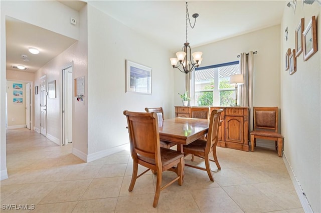 dining space featuring light tile patterned floors and a notable chandelier